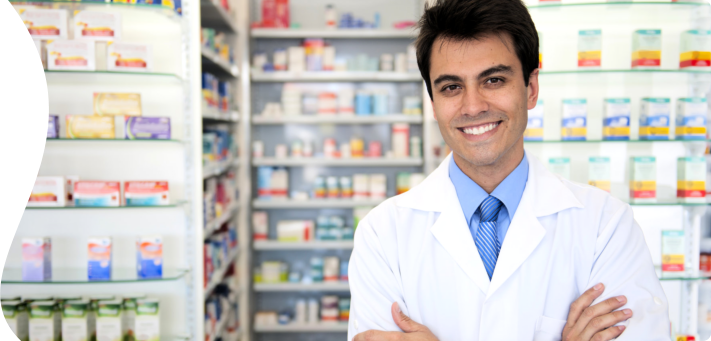 male pharmacist smiling at the camera